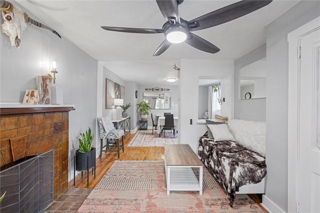 living room with hardwood / wood-style flooring and ceiling fan