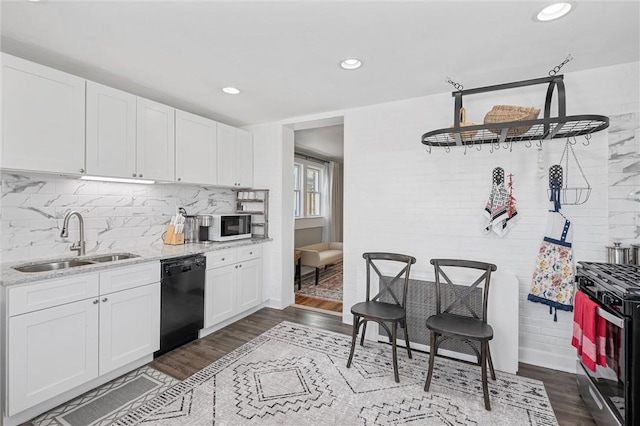 kitchen featuring sink, dishwasher, light stone counters, gas stove, and white cabinets