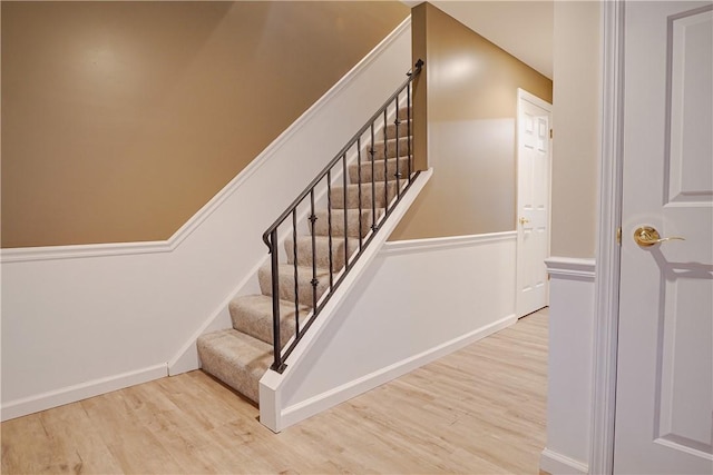 stairway with hardwood / wood-style flooring