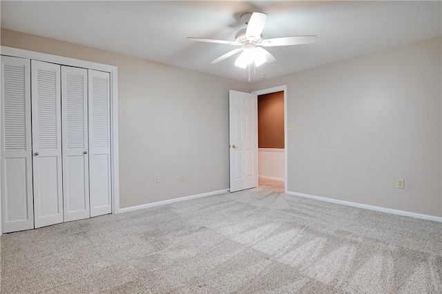 unfurnished bedroom with ceiling fan, light colored carpet, and a closet