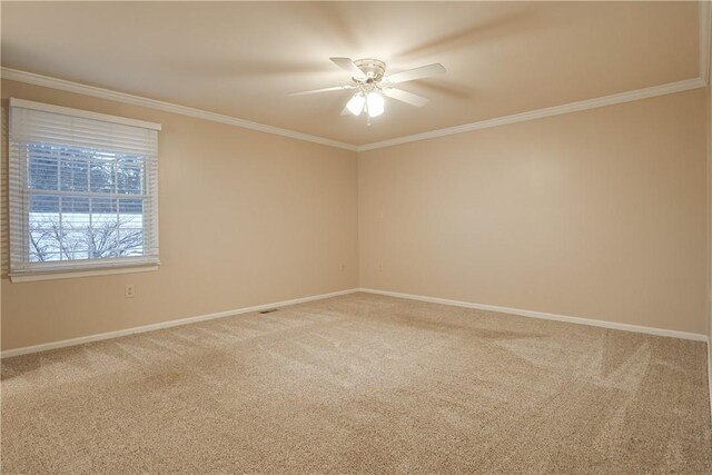 carpeted spare room with crown molding and ceiling fan