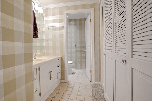 bathroom featuring tile patterned flooring, vanity, ornamental molding, and toilet