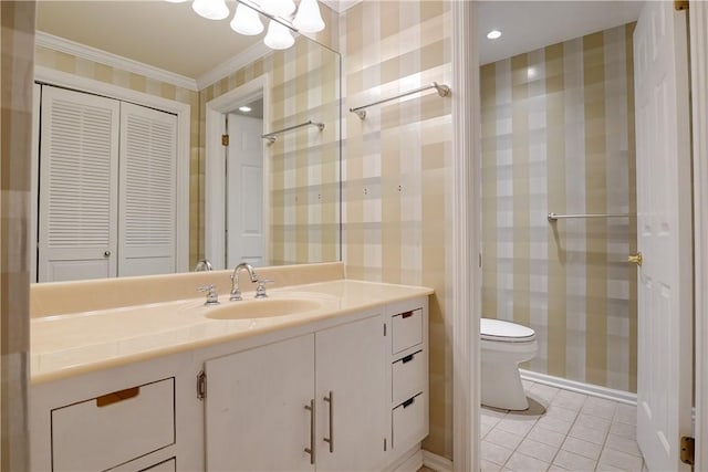 bathroom with tile patterned flooring, vanity, ornamental molding, and toilet