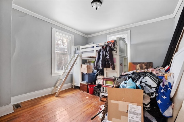 bedroom with crown molding and light wood-type flooring