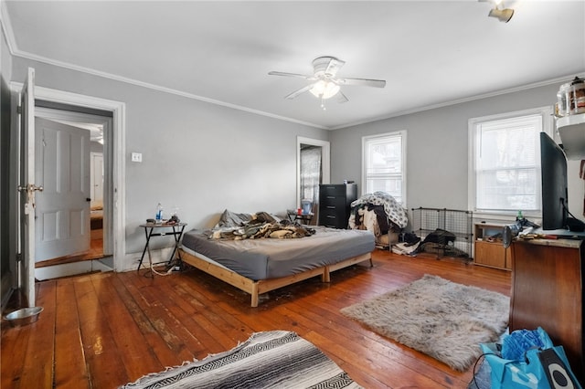 bedroom with ceiling fan, ornamental molding, and wood-type flooring