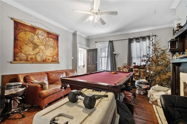 rec room with crown molding, pool table, wood-type flooring, a brick fireplace, and ceiling fan