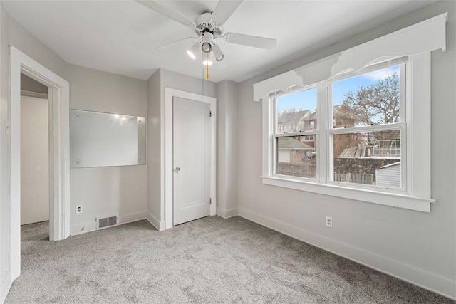 unfurnished bedroom with ceiling fan and light carpet