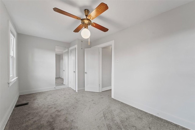 unfurnished bedroom with ceiling fan and light carpet