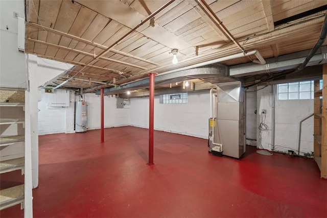 basement featuring heating unit and water heater