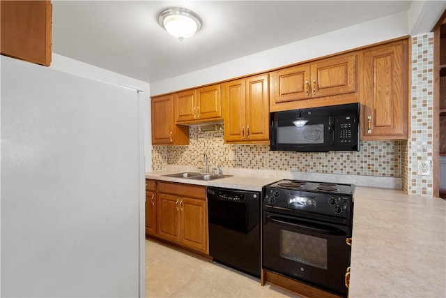 kitchen featuring sink, backsplash, and black appliances