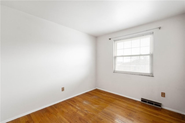 empty room with hardwood / wood-style flooring