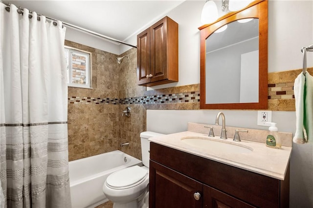 full bathroom with shower / tub combo with curtain, vanity, tile walls, and toilet