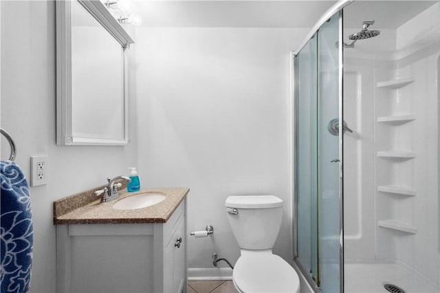 bathroom featuring an enclosed shower, vanity, tile patterned flooring, and toilet