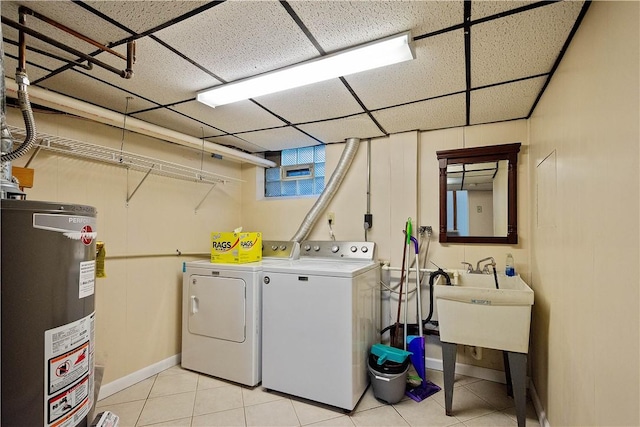 laundry area with light tile patterned floors, gas water heater, and independent washer and dryer