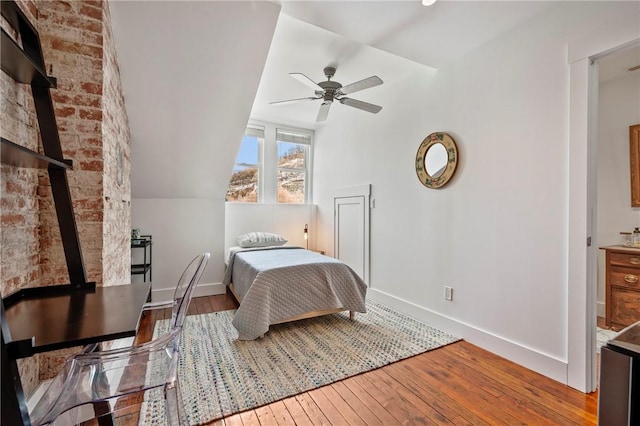 bedroom featuring vaulted ceiling, light hardwood / wood-style floors, and ceiling fan