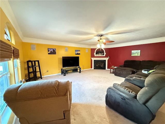 carpeted living room with ornamental molding and ceiling fan