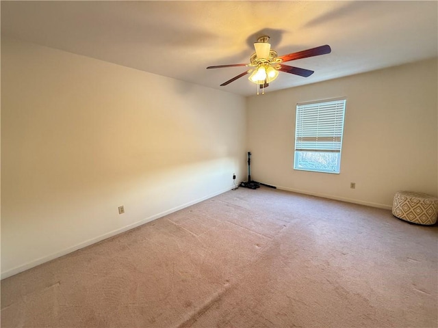 empty room featuring light colored carpet and ceiling fan