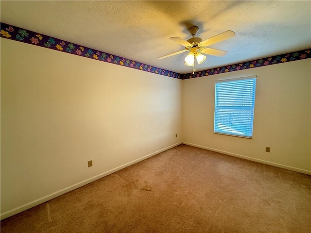 unfurnished room featuring a textured ceiling, ceiling fan, and carpet