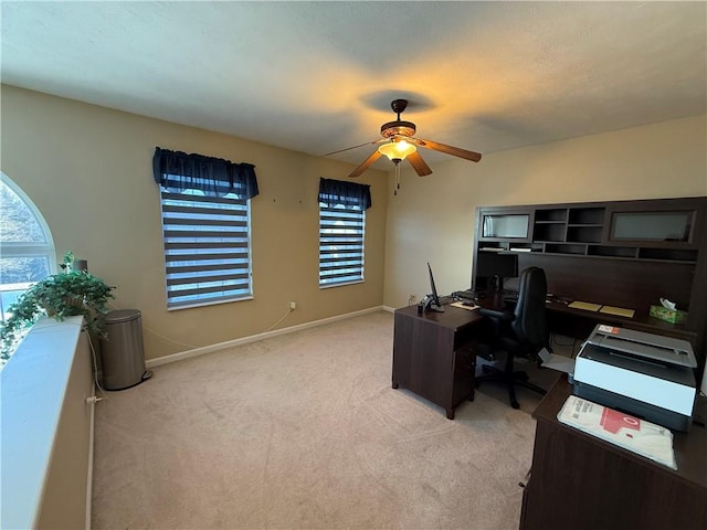 carpeted home office with ceiling fan