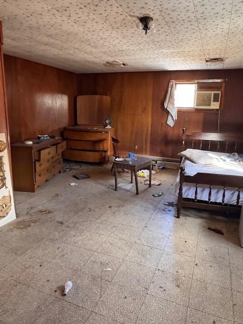 unfurnished bedroom featuring a wall mounted AC and wood walls