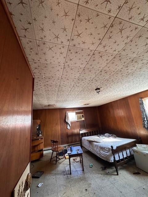 unfurnished bedroom featuring a wall mounted air conditioner and wood walls