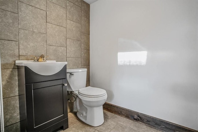 bathroom featuring tile patterned floors, vanity, and toilet