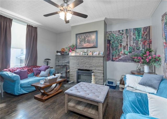 living room featuring crown molding, ceiling fan, wood-type flooring, and a fireplace