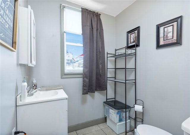 bathroom with tile patterned flooring, vanity, and toilet