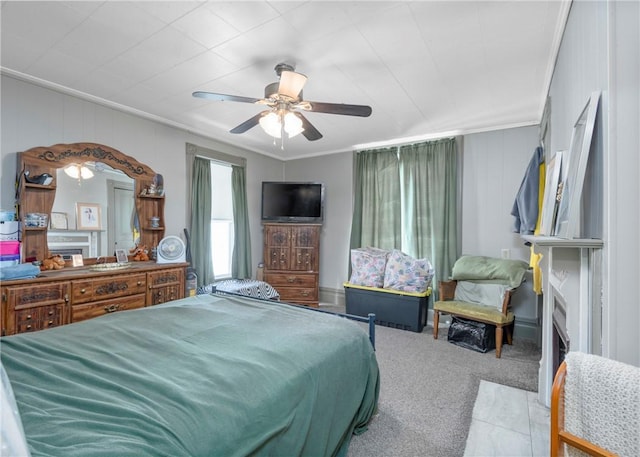 carpeted bedroom featuring crown molding and ceiling fan