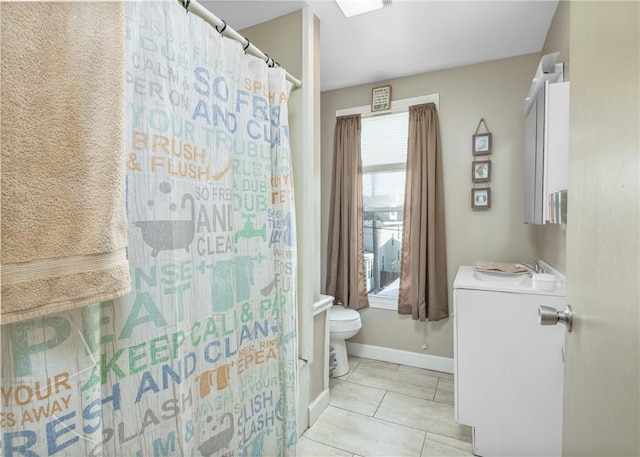 bathroom featuring sink, a shower with curtain, tile patterned floors, and toilet