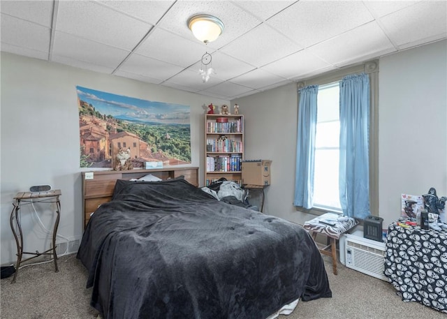 bedroom with a paneled ceiling and carpet flooring