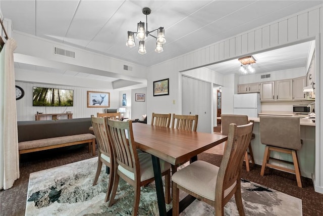 dining room with a notable chandelier