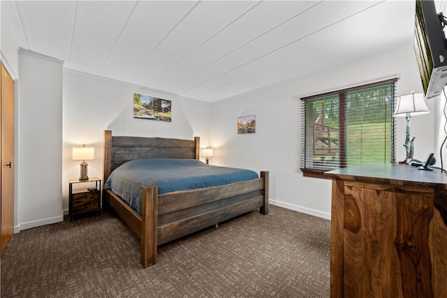 bedroom with dark colored carpet