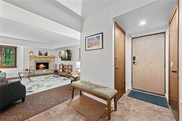 foyer featuring wooden walls and a fireplace