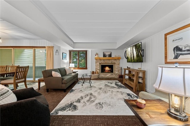 living room with a stone fireplace