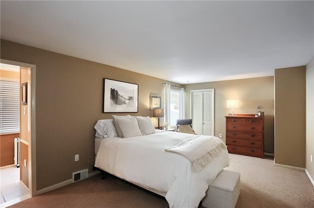 bedroom with carpet floors and a closet