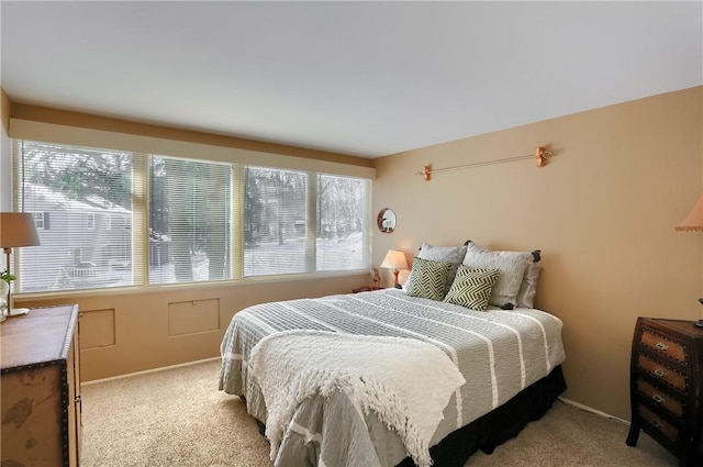 bedroom featuring light colored carpet