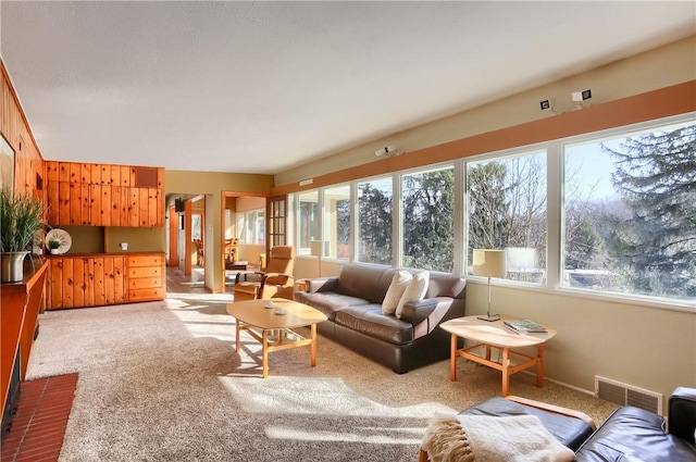 living room with light colored carpet and plenty of natural light