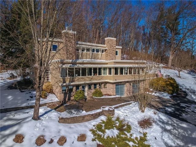 view of snow covered back of property