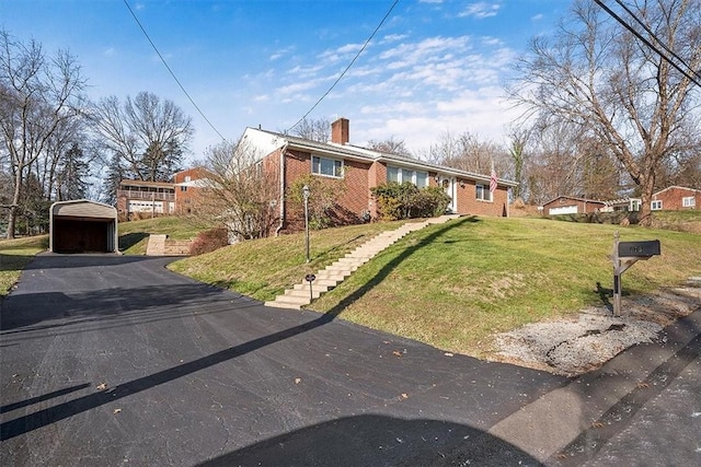 view of front of property featuring a carport and a front yard