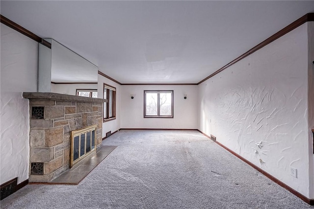 unfurnished living room with a fireplace, carpet floors, and ornamental molding