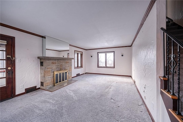 unfurnished living room featuring a stone fireplace, carpet floors, and ornamental molding