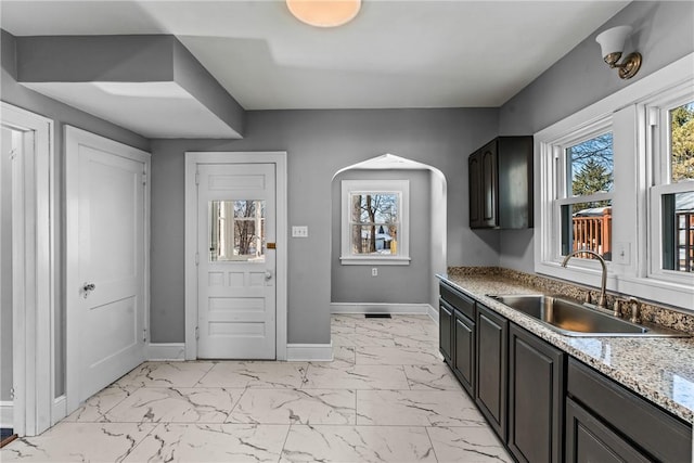 kitchen featuring sink and dark brown cabinets