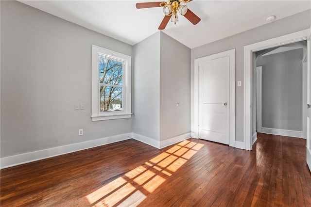 unfurnished bedroom with ceiling fan and dark hardwood / wood-style flooring