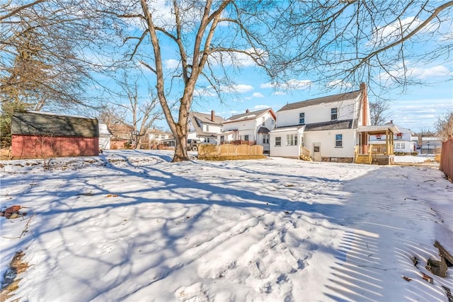 view of snow covered rear of property