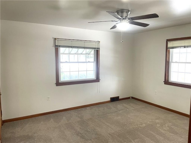 empty room featuring carpet floors and ceiling fan