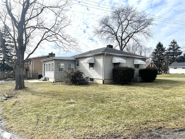 rear view of house with a yard and central air condition unit