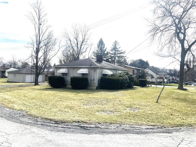 view of side of property with a yard