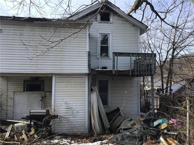 back of house featuring a balcony