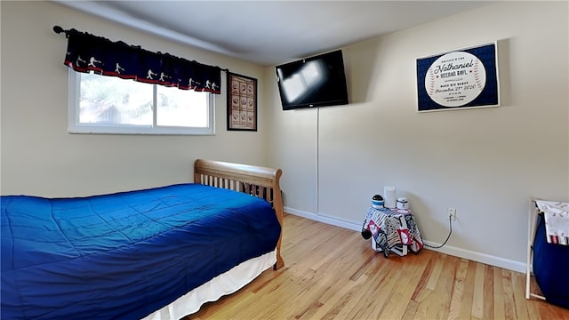 bedroom with hardwood / wood-style flooring